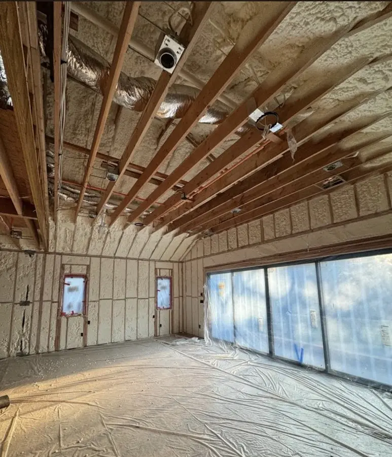 Interior walls and ceiling insulated with spray foam during new construction in Homestead Meadows North